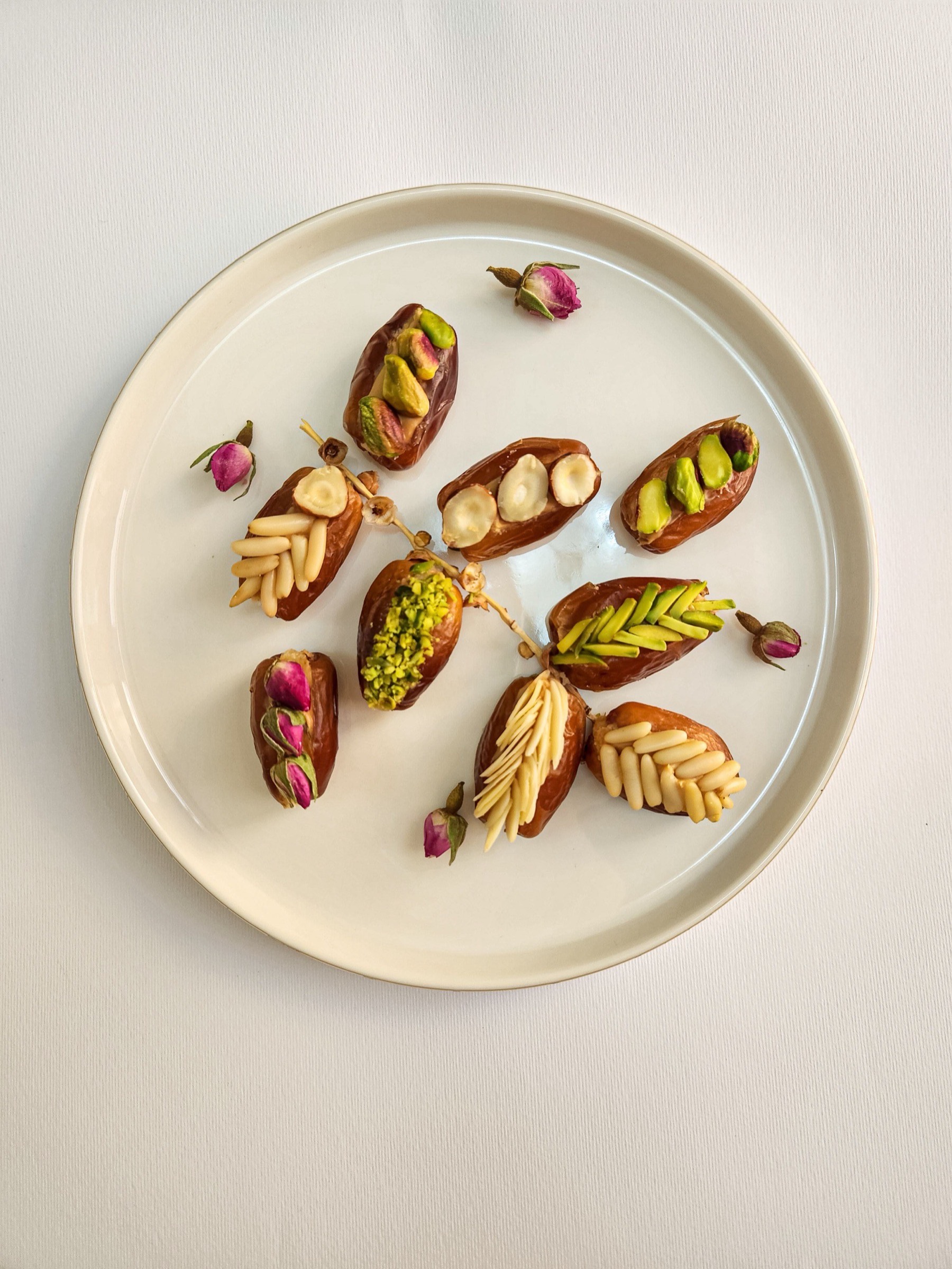Deglet Nour dates plated and stuffed with pistachio, almond, and dried rose