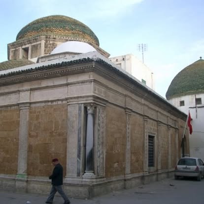 Historic Tunisian architecture, evoking centuries of olive cultivation